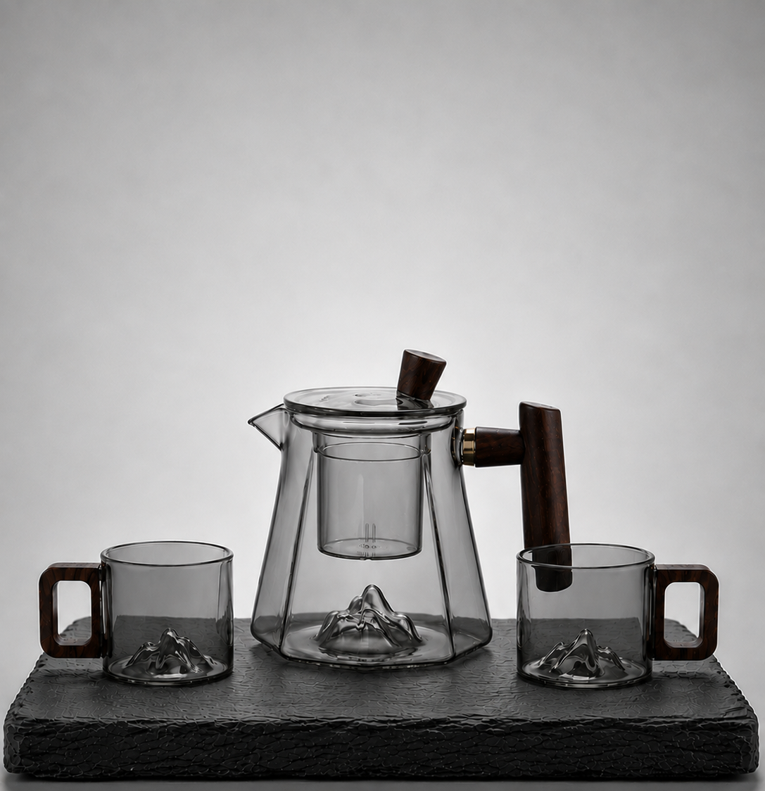 A glass teapot and two matching cups 
