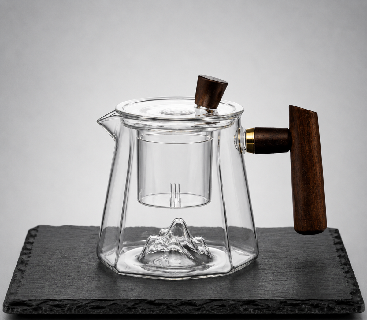 Clear glass teapot with a mountain-shaped bottom design